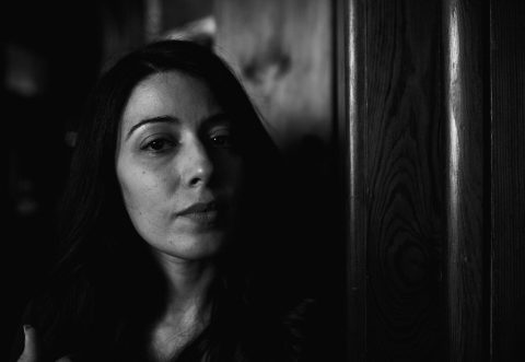 Black and White image of Elizabeth Tabish on set of the short film The Method of Places 2019. Image shot by Joshua David Curtis